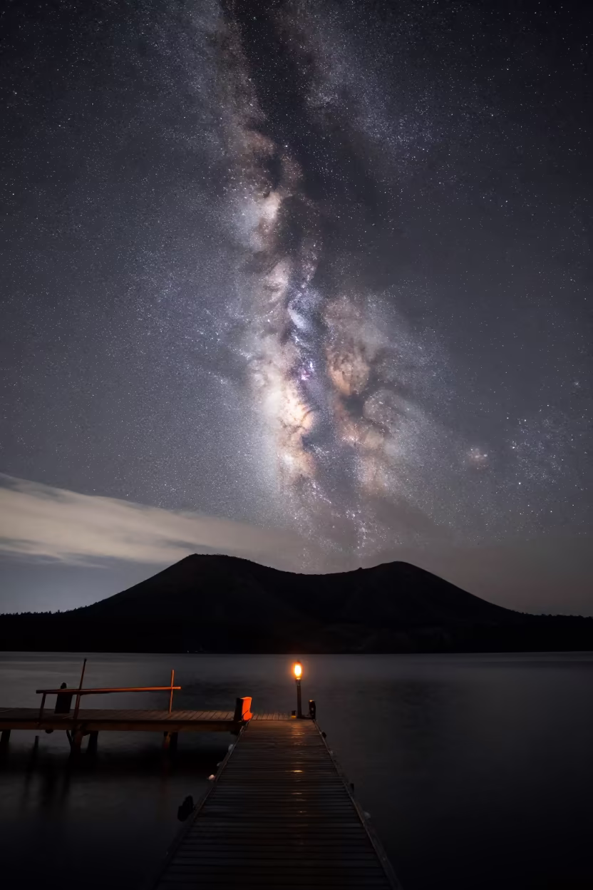 Milky Way Core Over Volcanic Crater Harbor in beside a lantern-dotted harbor in Canada