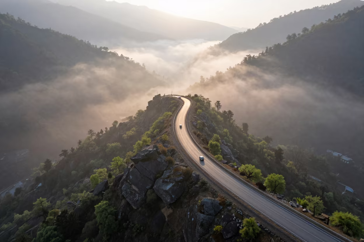 Misty Dawn Causeway Traffic Over Kathmandu Valley in at a rocky saddle overlooking a mountain valley near Kathmandu