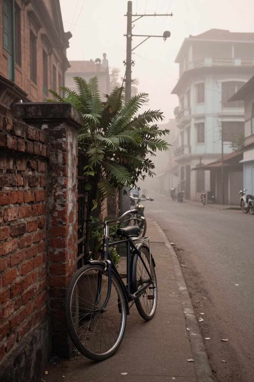 Misty Dawn Street Scene in Kolkata India with Bicycle and Plant Pot in in Kolkata, India