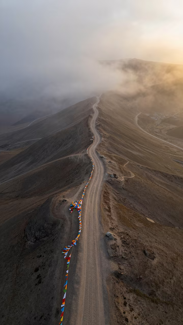 Misty Desert Tracks Beneath Prayer Flags Lhasa in along a high mountain pass beneath prayer flags near Lhasa