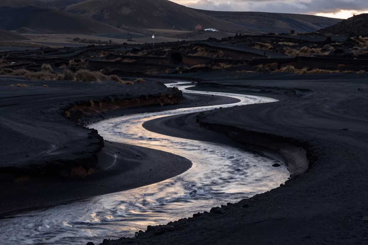 Moonlit Glacial River Over Black Volcanic Sand in from a ridge above layered foothills near Plaza de Armas, Cusco