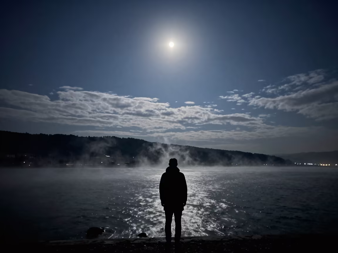 Moonlit Surf Silhouette Winter City Ridge in beneath thin cloud gaps and stars near Bishkek