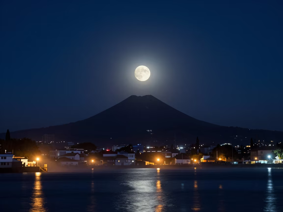 Moonrise Over Volcano at Guapulo Harbor Night in beside a lantern-dotted harbor near Guapulo, Quito