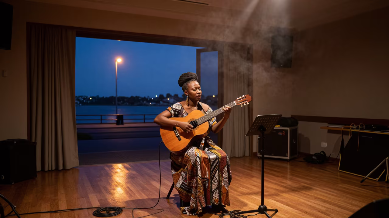 Morna singer with guitar under harbor streetlamp in in a rehearsal room in Sydney