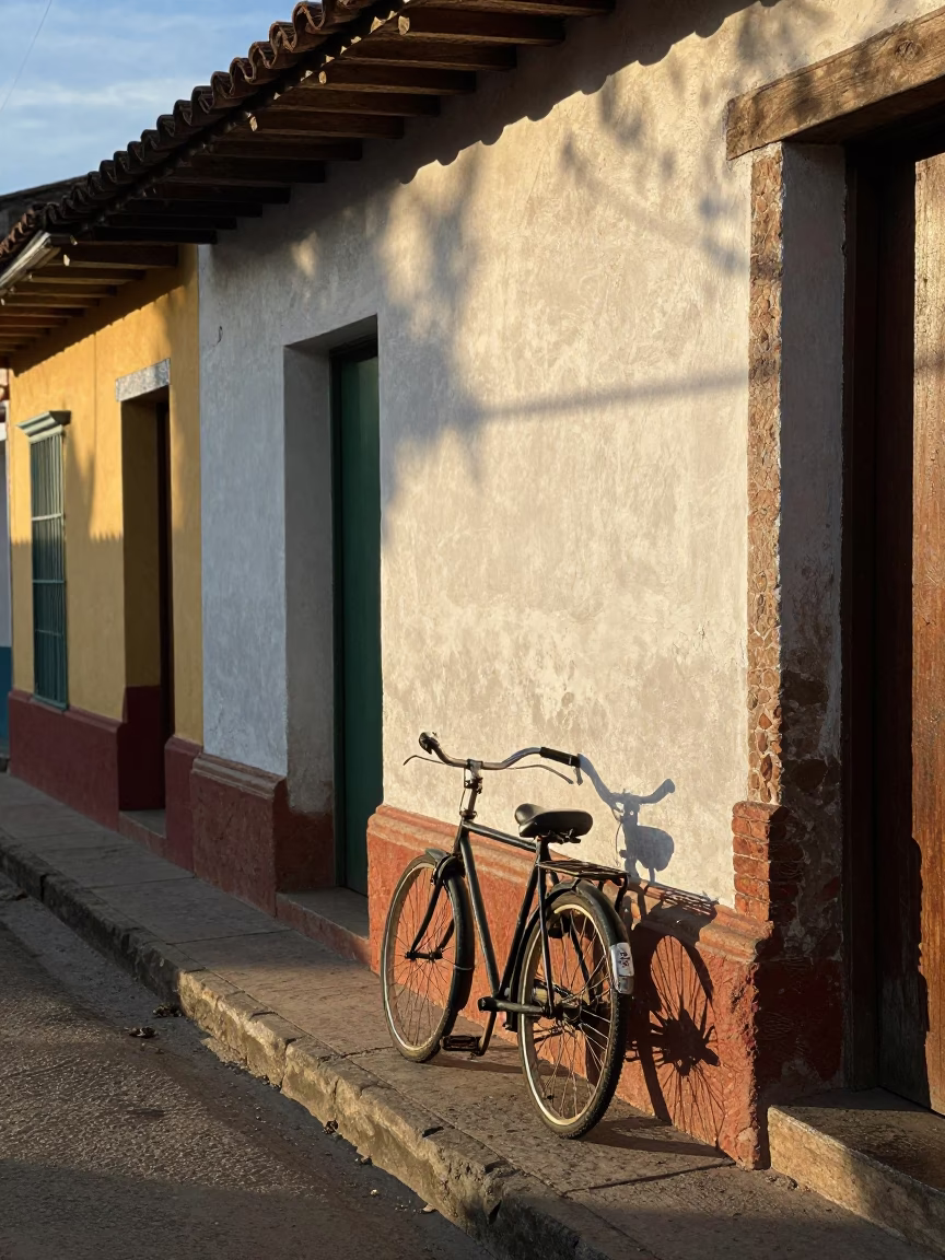 Morning light illuminates vintage bicycle against colonial wall in Medellin Colombia street scene in in Medellin, Colombia
