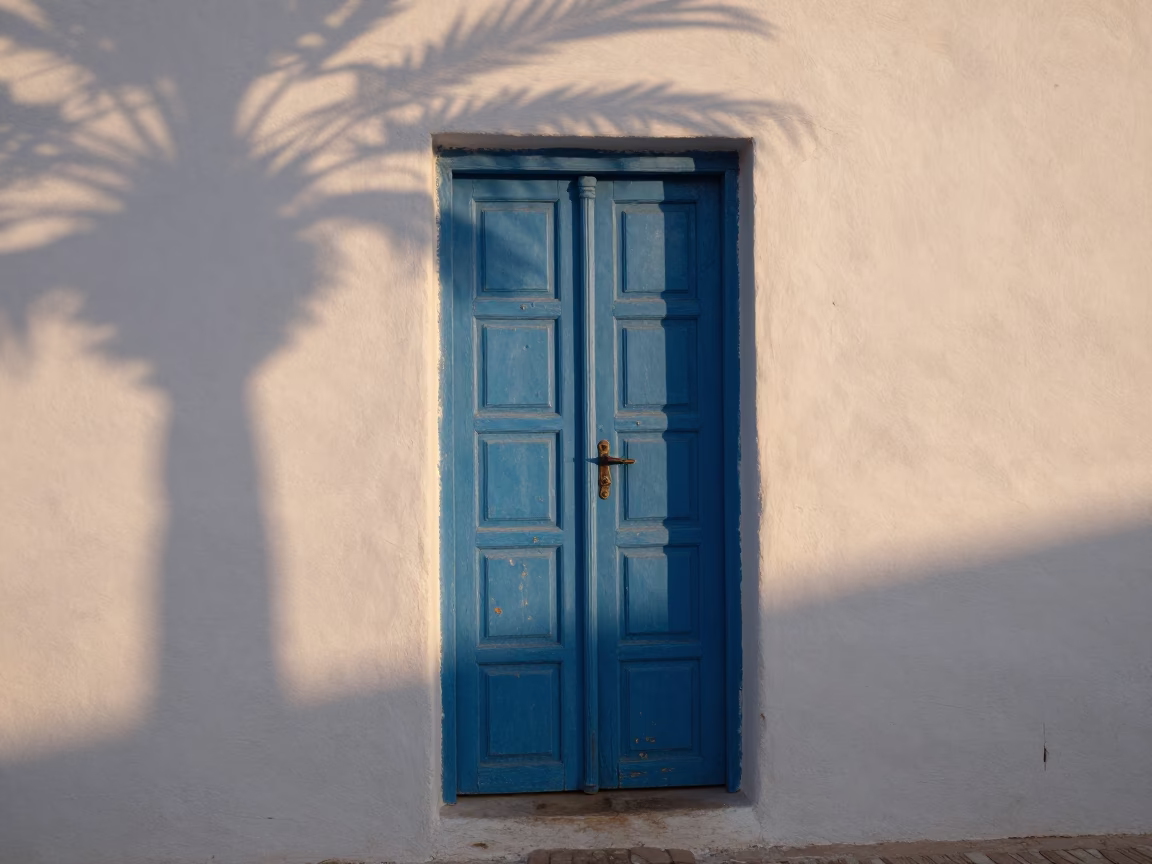 Morning Light in Essaouira Morocco Blue Door and Wicker Shadow in in Essaouira, Morocco