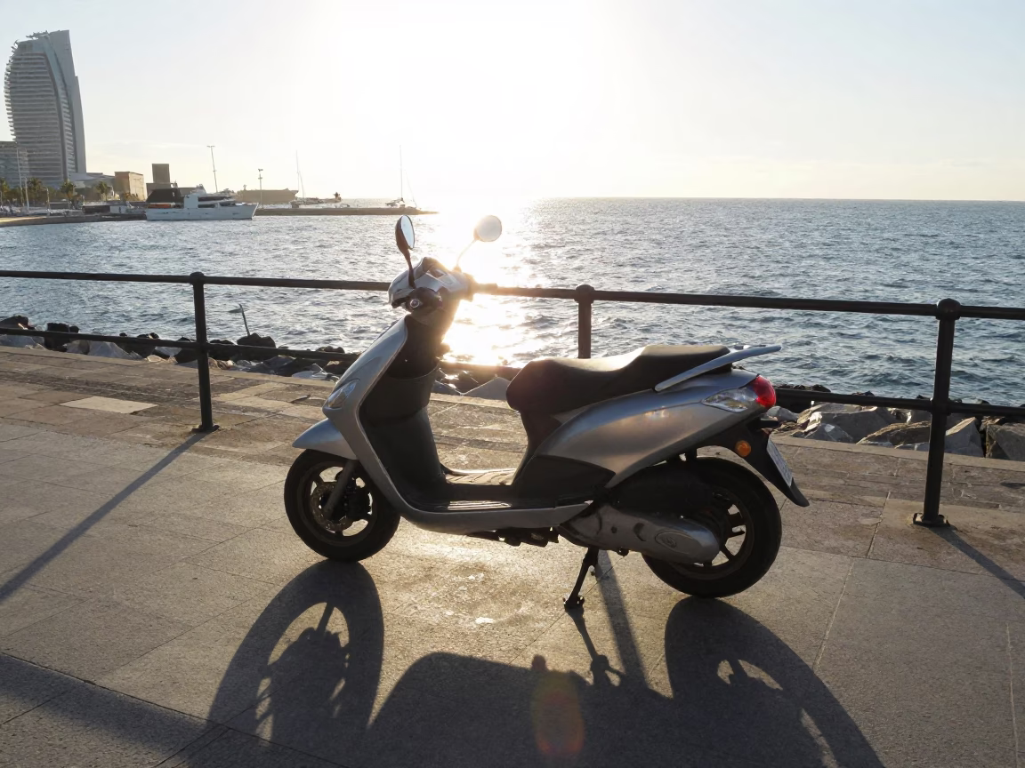 Morning light on Barcelona harbor promenade with parked scooter and distant sea view in in Barcelona, Spain