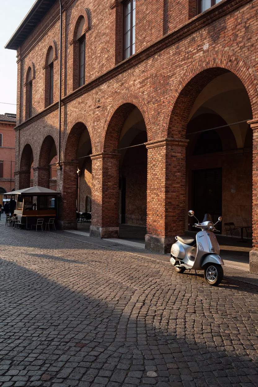 Morning Light on Bologna Cobblestones with Vintage Scooter and Coffee Shop Exterior in in Bologna, Italy