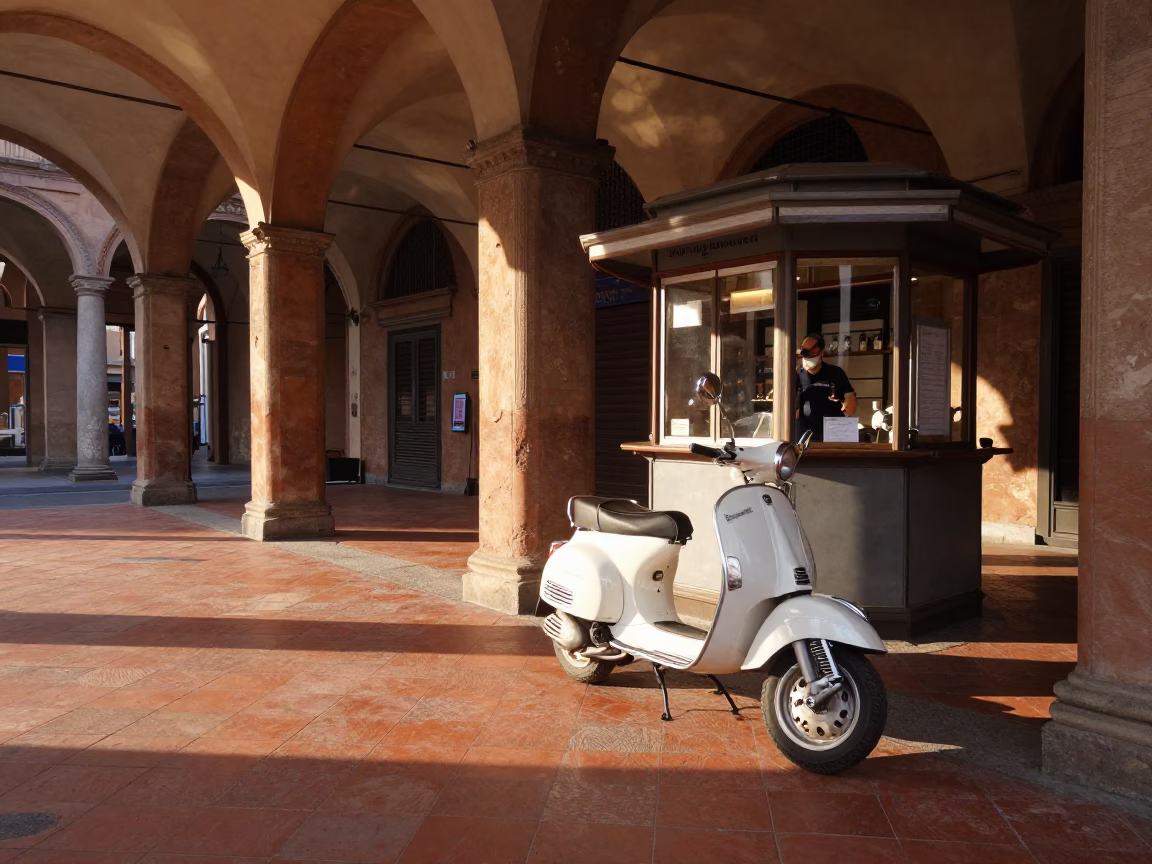 Morning light on Bologna porticoes with vintage Vespa and espresso stand in in Bologna, Italy