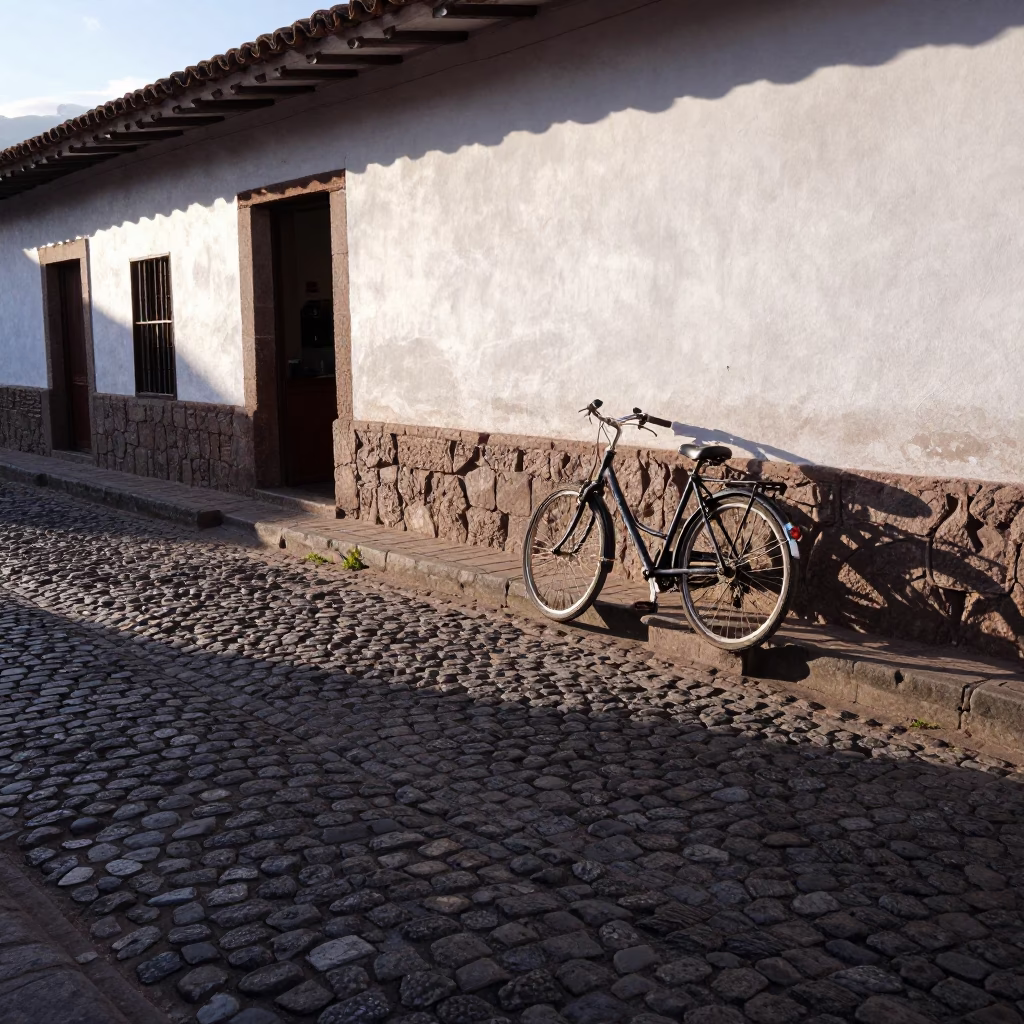 Morning Light on Cusco Cobblestone Street with Bicycle and Colonial Architecture in in Cusco, Peru