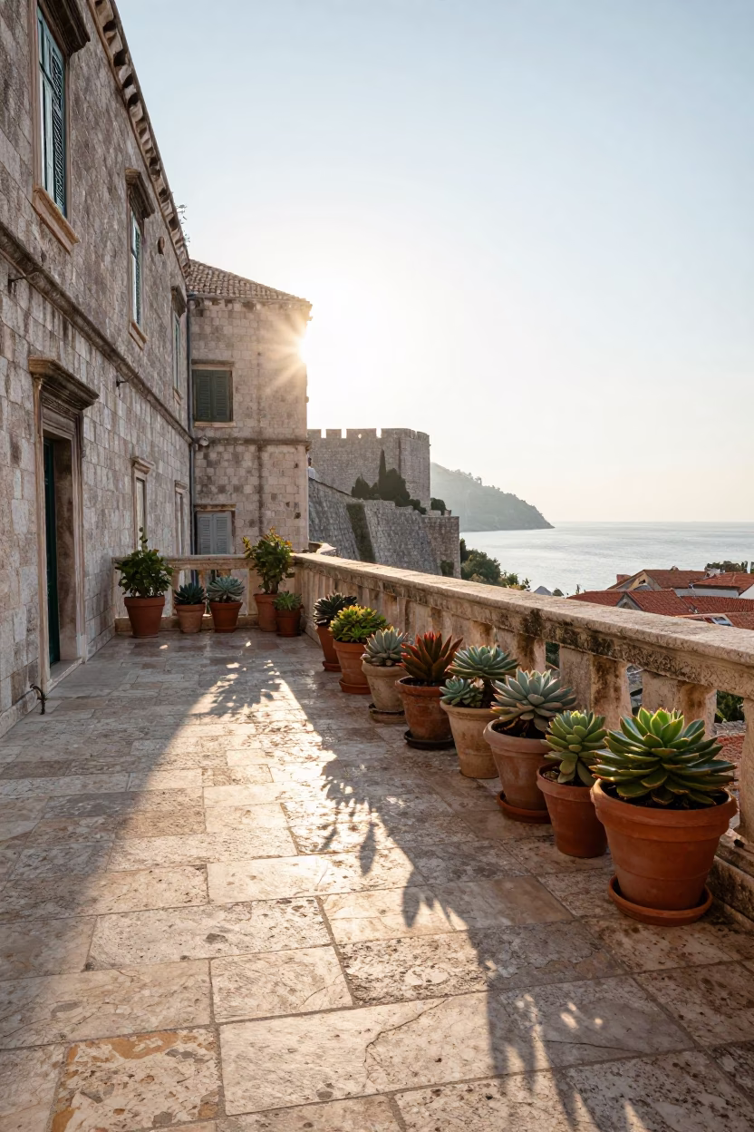 Morning light on Dubrovnik stone terrace with terracotta pots and linen details in in Dubrovnik, Croatia