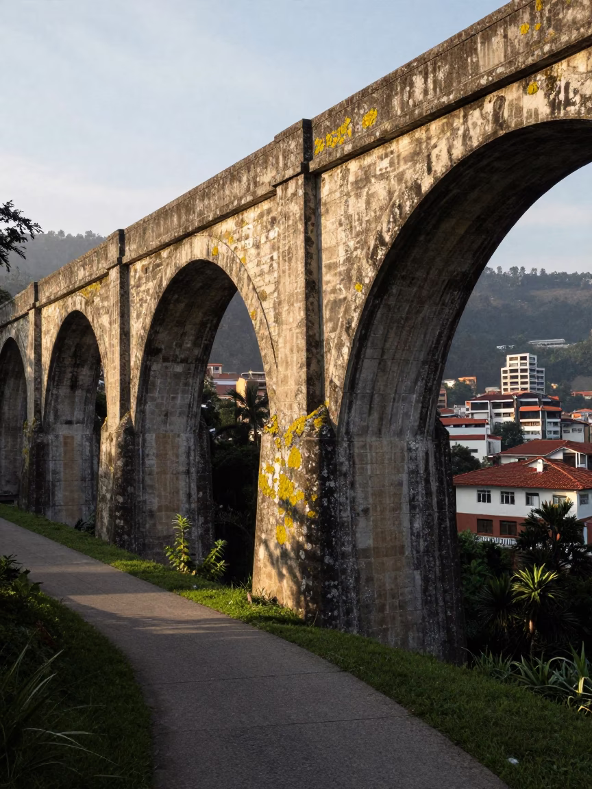 Morning Light on Medellin Aqueduct Path with Lichen Parapets and Vintage Street Scene in in Medellin, Colombia