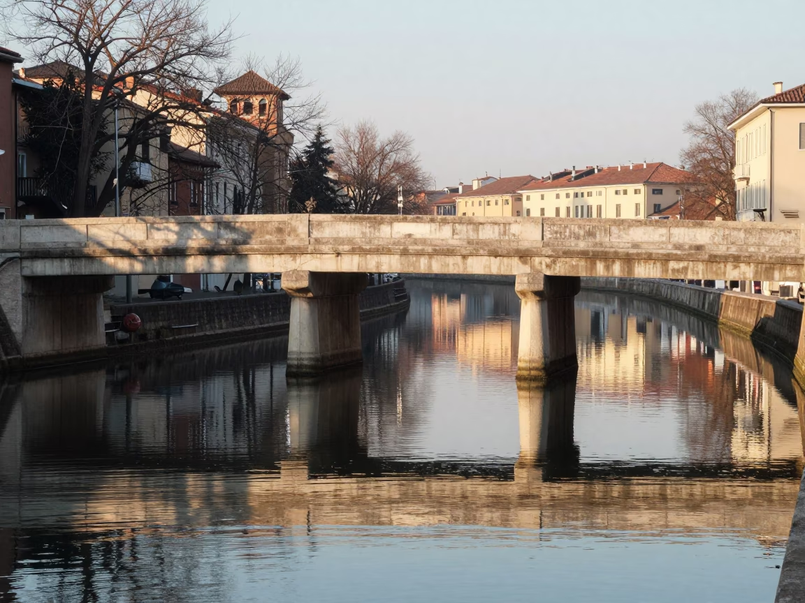 Morning Light on Milan Bridge Pier and Waterfront Reflections in in Milan, Italy