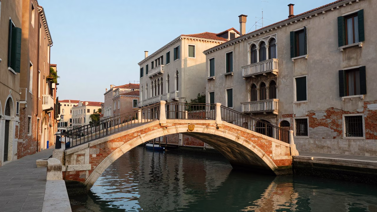 Morning Light on Venice Canal Bridge with Local Trash Bin and Pomegranate Tree in in Venice, Italy