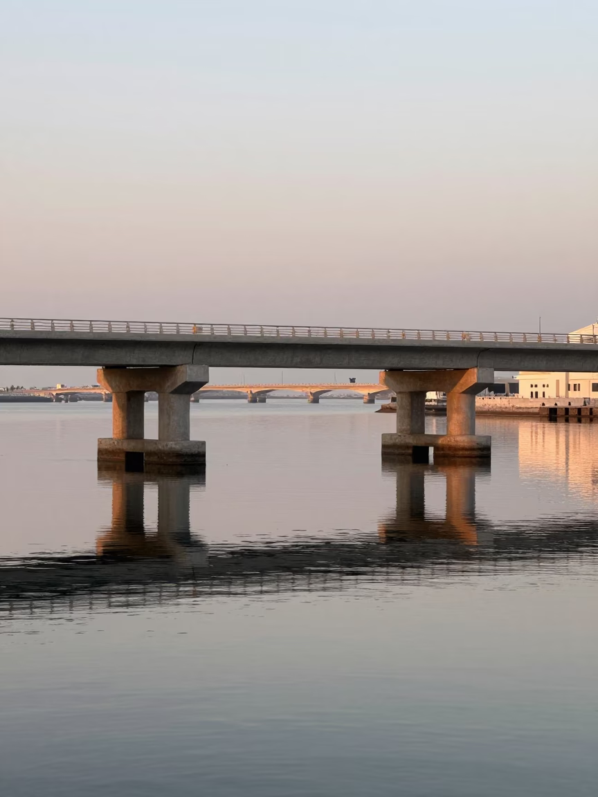 Morning Light Reflecting on Muscat Waterfront Bridge Piers and Harbor Activity in in Muscat, Oman