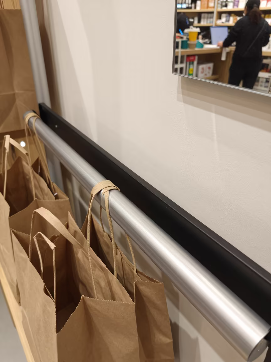 Morning Retail Belt with Tote Stacks in Lijiang in inside a bright retail aisle in Lijiang