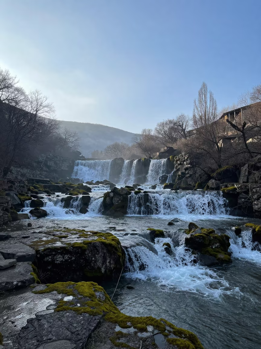 Mossy Terraced Waterfall in Dawn Valley Near Vera in across a wide valley floor near Vera, Tbilisi