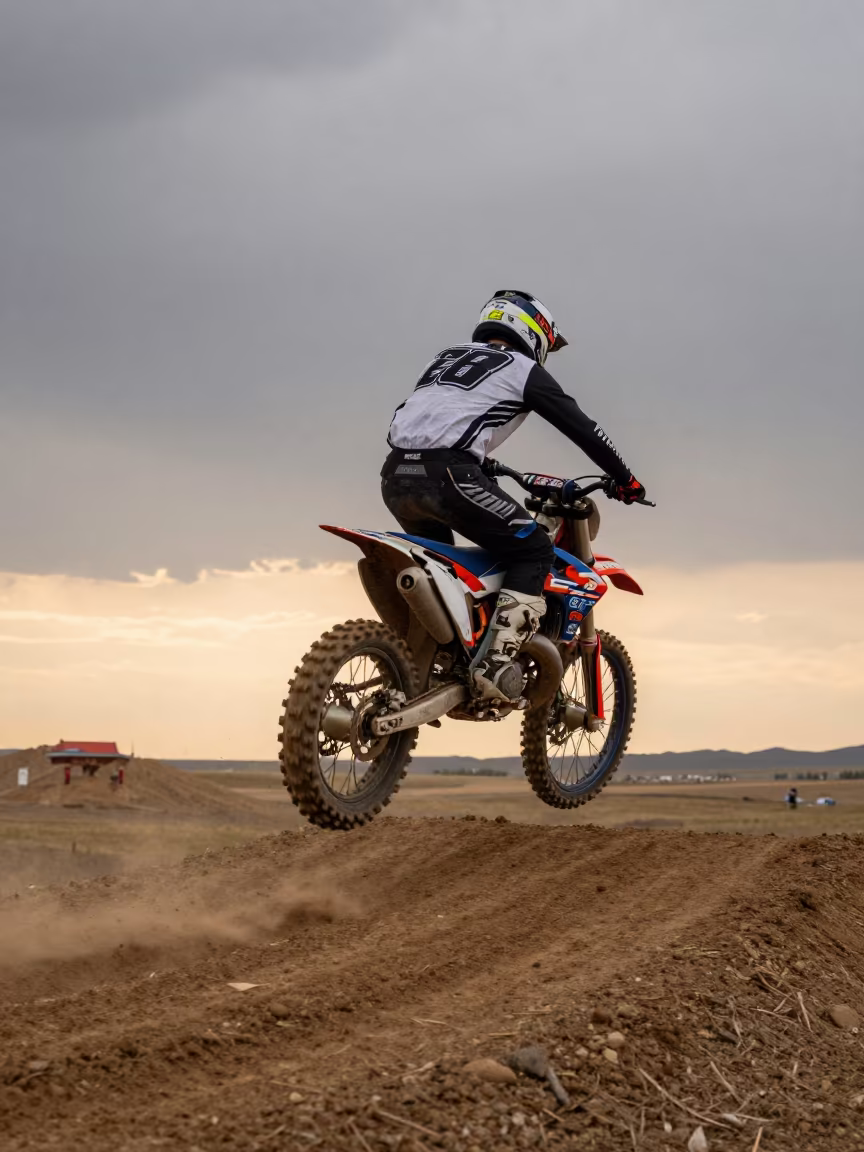 Motocross Rider Scrubbing Jump at Ulaanbaatar Sunset in in Ulaanbaatar