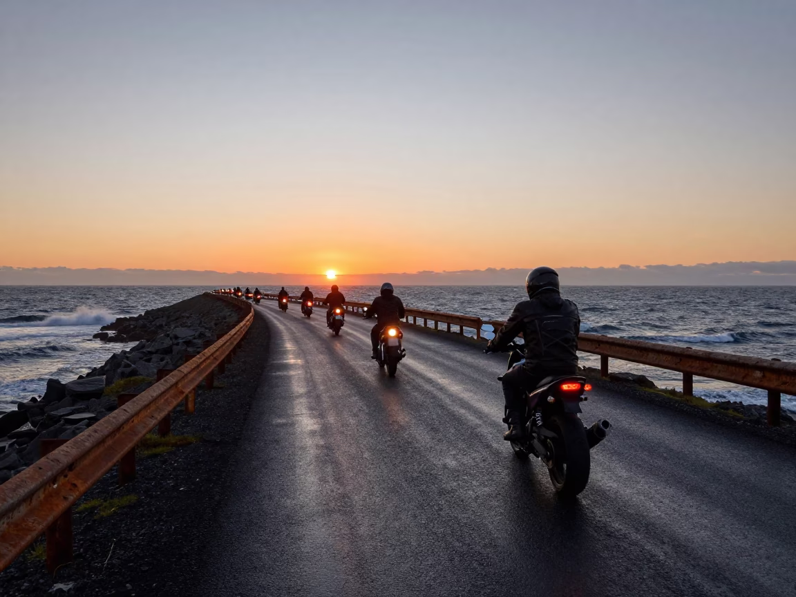 Motorcycle convoy on Icelandic causeway sunset in on a wind-open causeway in Iceland