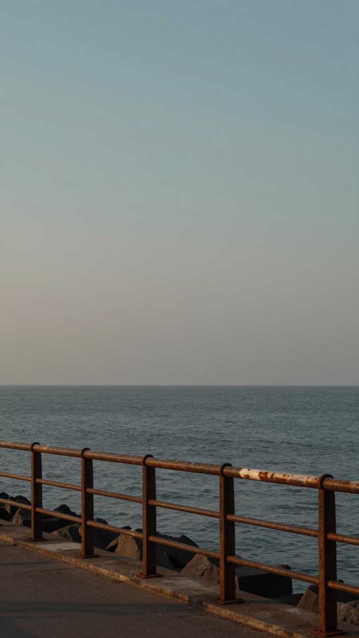 Mumbai Coastal Dawn Scene with Rusty Metal Railing and Bougainvillea Flowers in in Mumbai, India