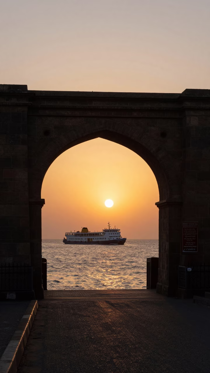 Mumbai Gateway of India sunset silhouette with ferry crossing Arabian Sea horizon in in Mumbai, India