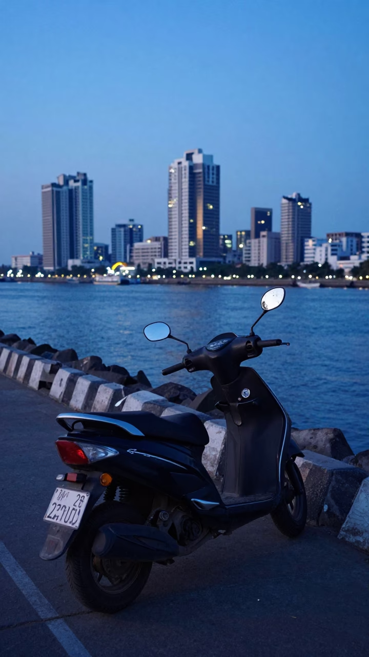 Mumbai Harbor Promenade at Blue Hour with Parked Scooter and City Skyline Lights in in Mumbai, India
