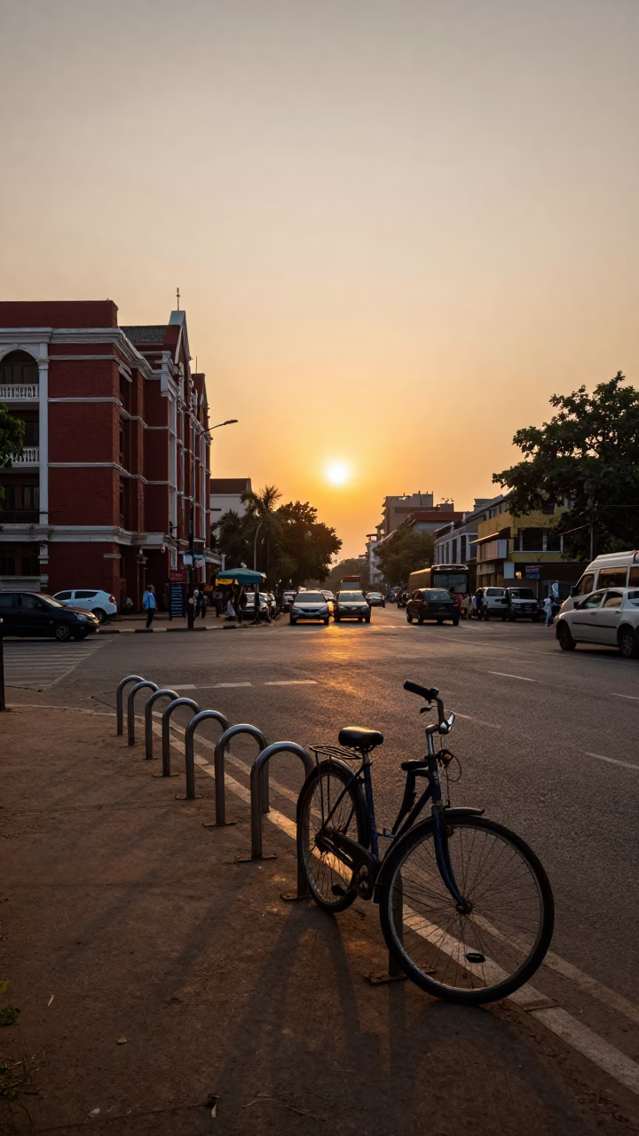 Mumbai street scene at sunset with bicycle racks and red brick buildings in in Mumbai, India
