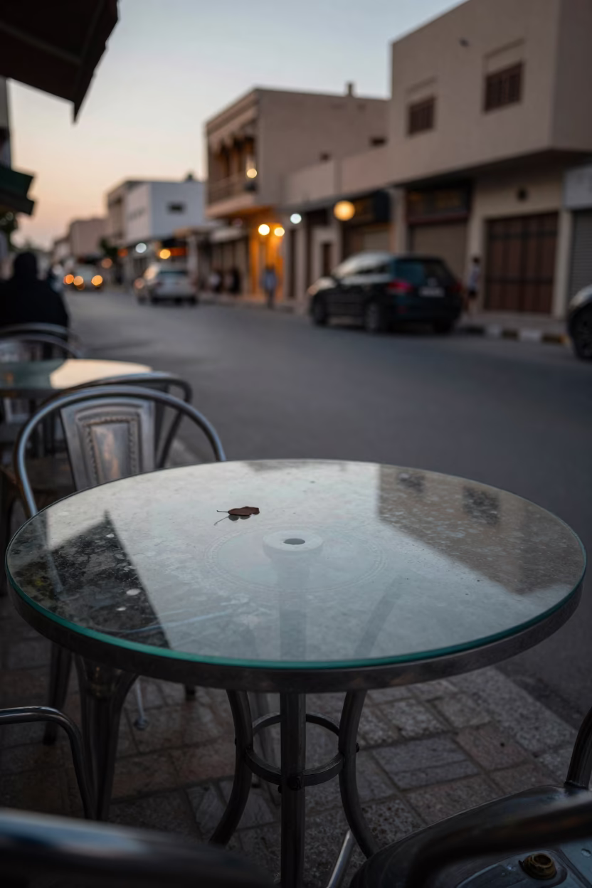 Muscat Oman Early Evening Street Scene with Clear Glass Tabletop and Leaf Shadows in in Muscat, Oman