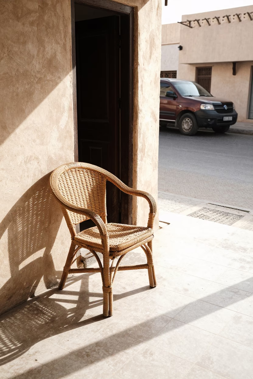 Muscat Oman Late Morning Street Scene with Rattan Chair and Wicker Shadows on Tile in in Muscat, Oman