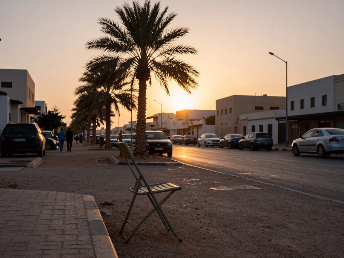 Muscat Oman Sunset Street Scene with Date Palm and Folding Chair in in Muscat, Oman