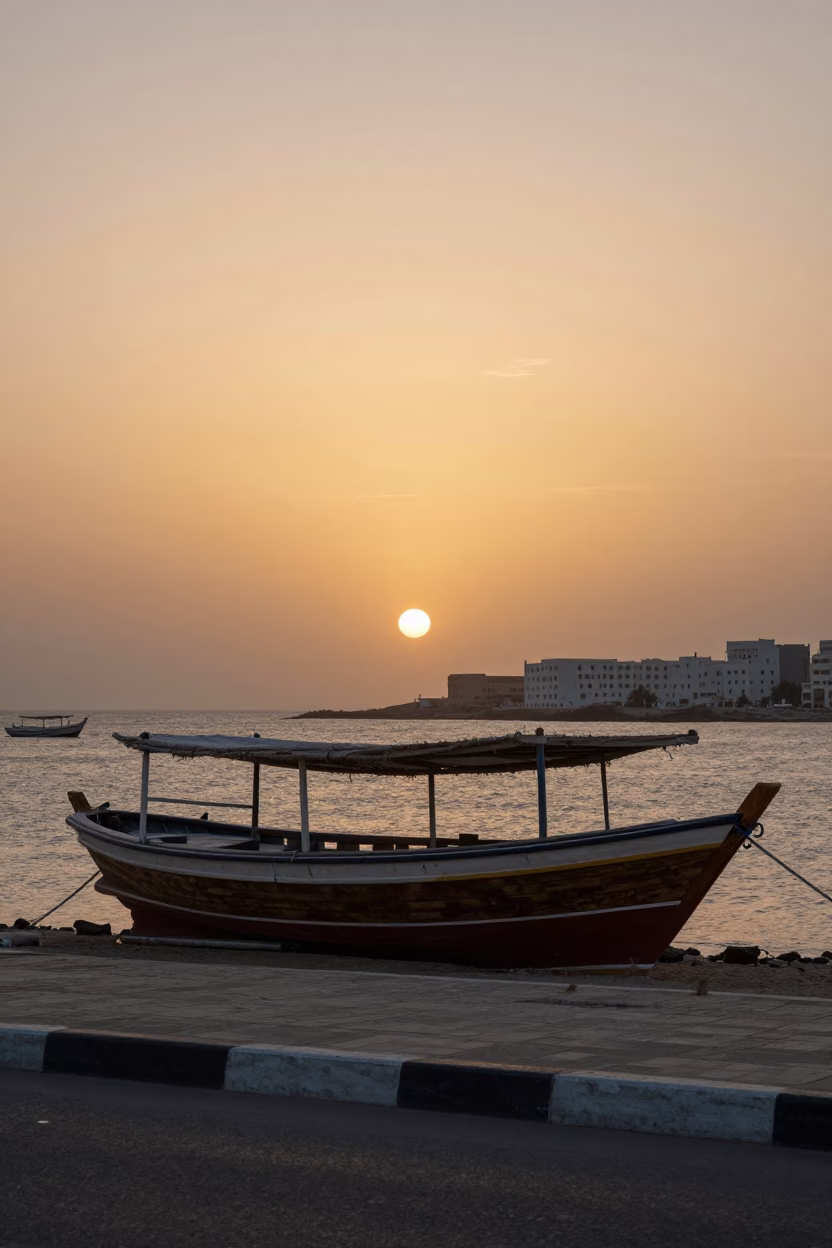 Muscat Oman Sunset Street Scene with Traditional Dhow Boats and Urban Architecture in in Muscat, Oman