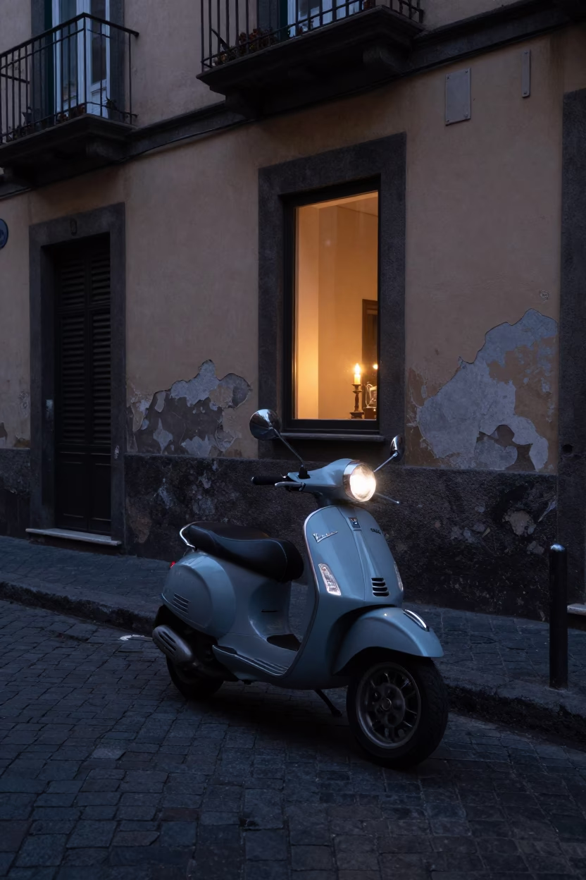 Naples Italy pre-dawn street scene with scooter and candlelit window in in Naples, Italy