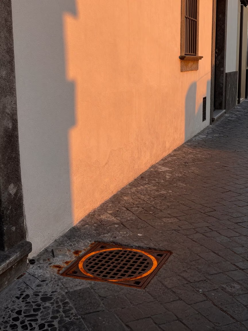 Naples Italy Sunset Street Scene with Rust Drain and Steel Mirror in in Naples, Italy
