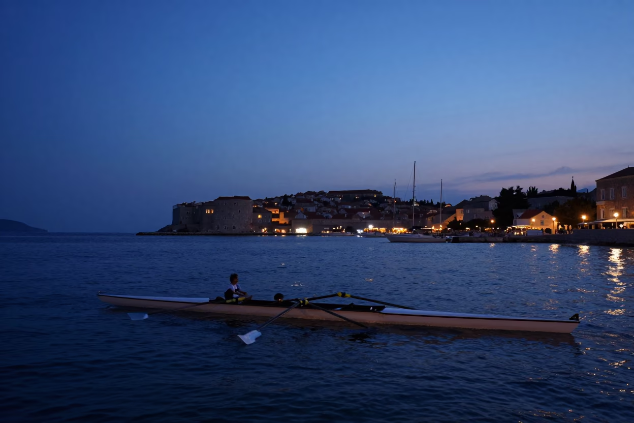 Nautical Dawn Light Over Dubrovnik Harbor With Rowing Shell on Calm Adriatic Waters in in Dubrovnik, Croatia