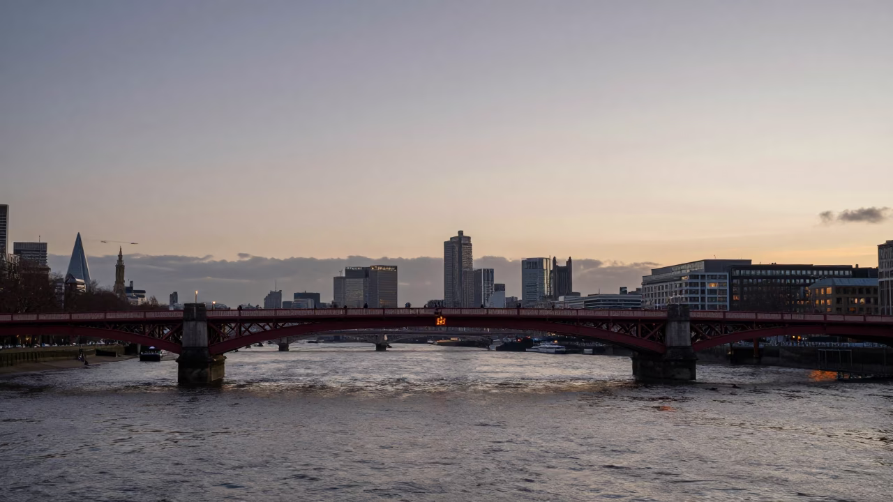 Nautical Dawn Light Over Thames River with Red Bridge and Urban Silhouette in in London, United Kingdom