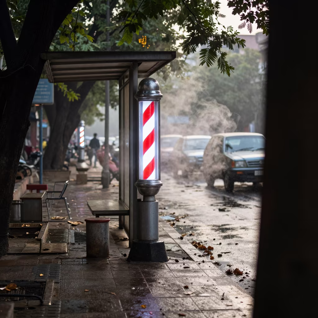 Neon Barber Pole Above Wet Street in Lucknow in beside a steamed-up bus shelter in Lucknow
