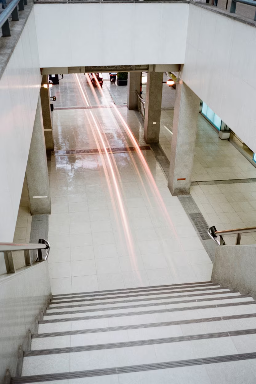 Neon Ferris Wheel Light Trails Over Tiled Stairs in inside a tiled stair hall in Binh Thanh, Ho Chi Minh City