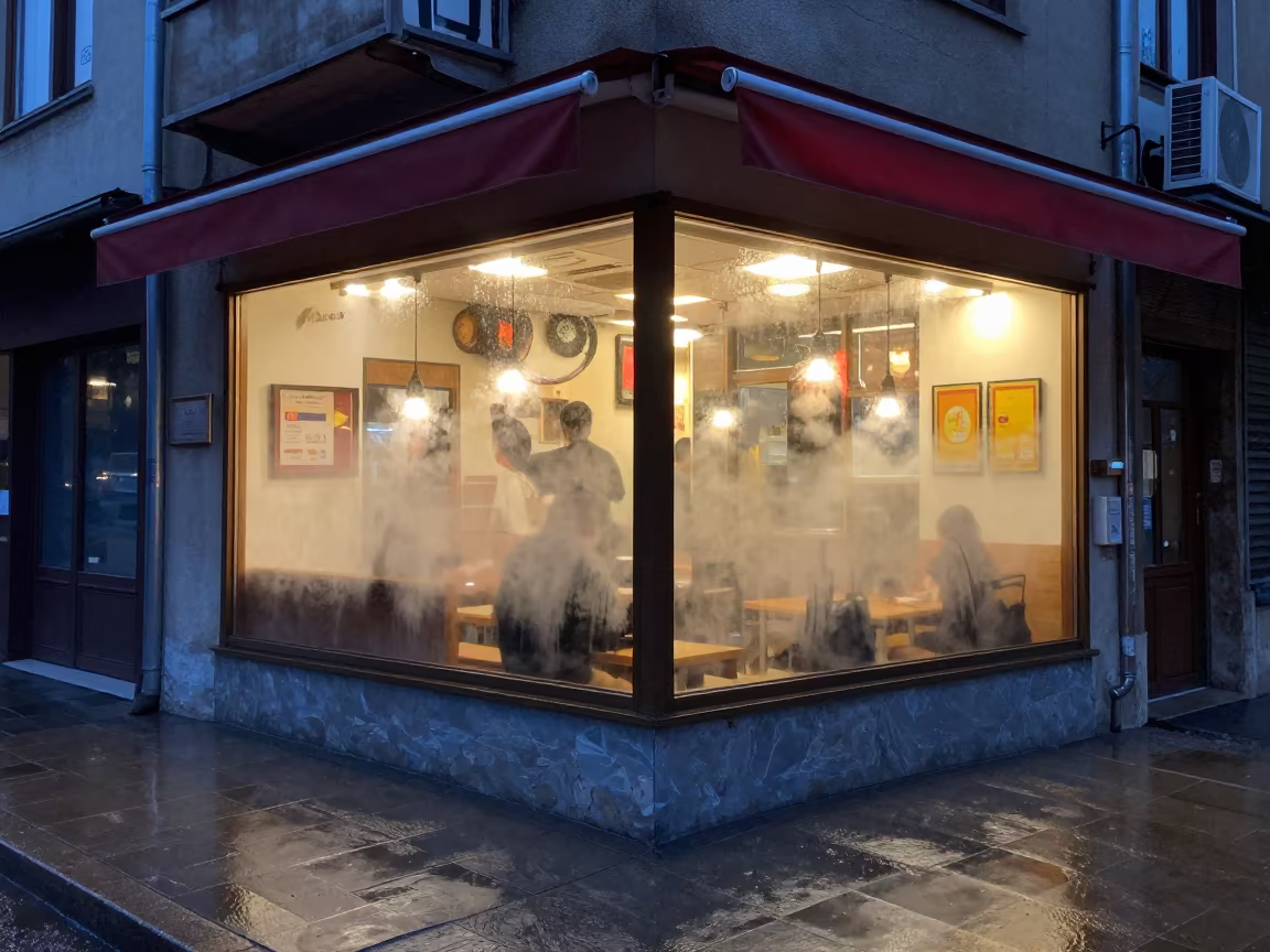 Neon Ramen Shop Window Fogging Rainy Night Skopje in beneath a shop awning at blue hour in Skopje