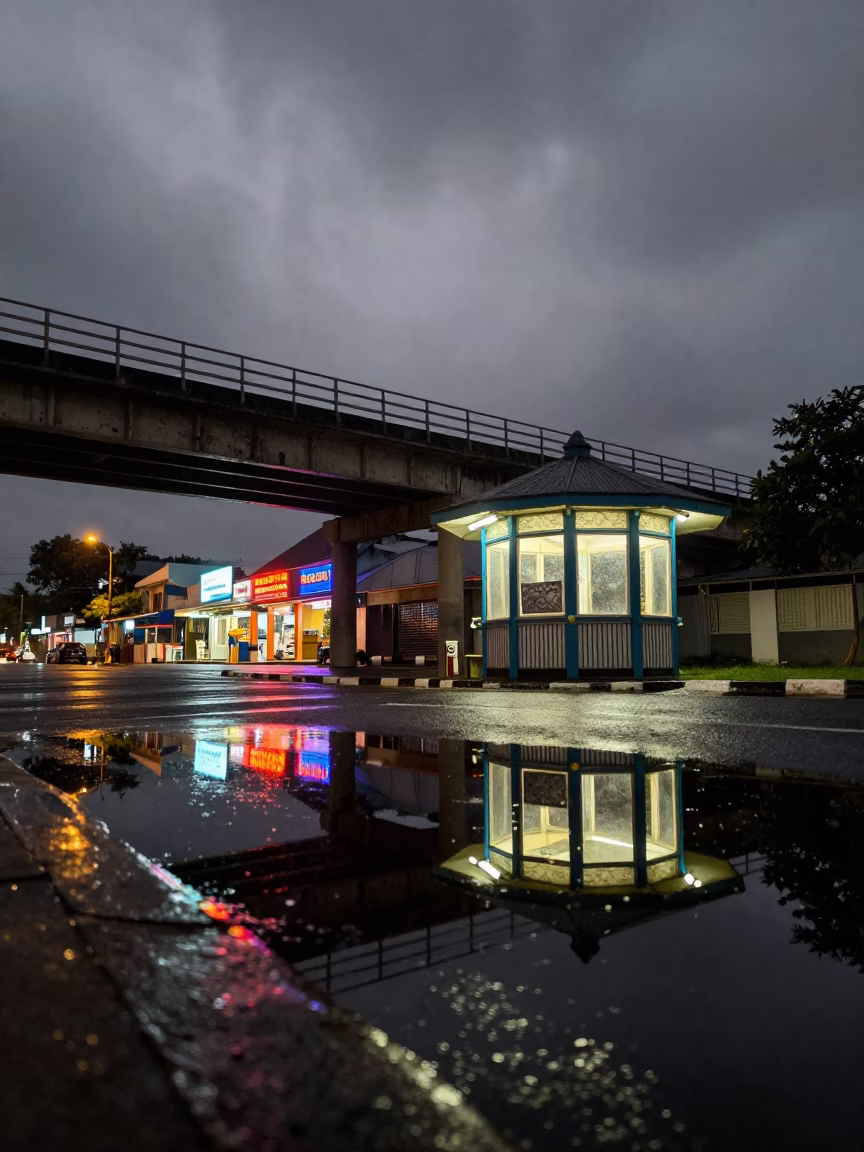 Neon Reflection of Overpass in Rainy Malindi Street in by a rain-darkened kiosk in Malindi