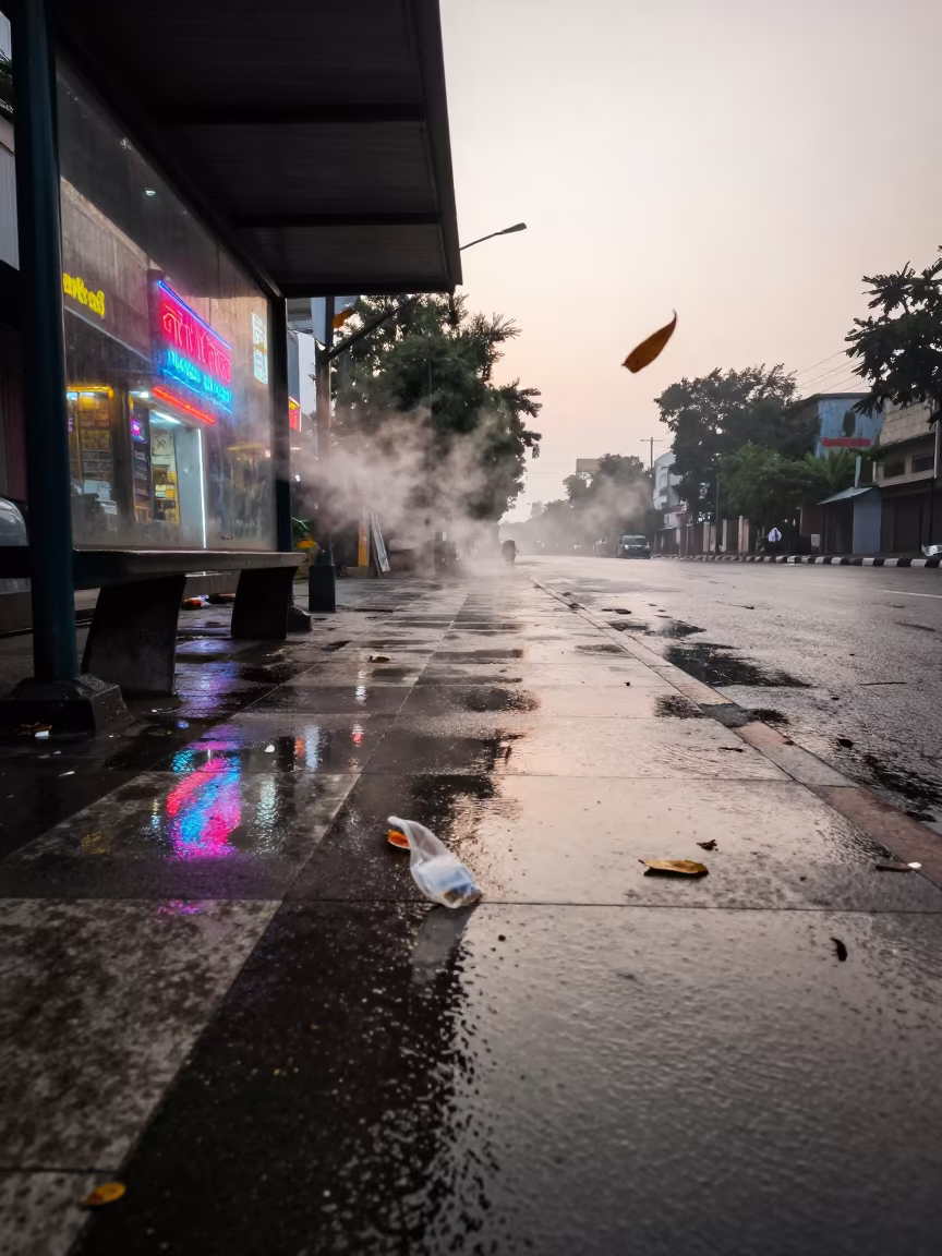 Neon Reflections Floating Over Wet Pavement in Okara in beside a steamed-up bus shelter in Okara