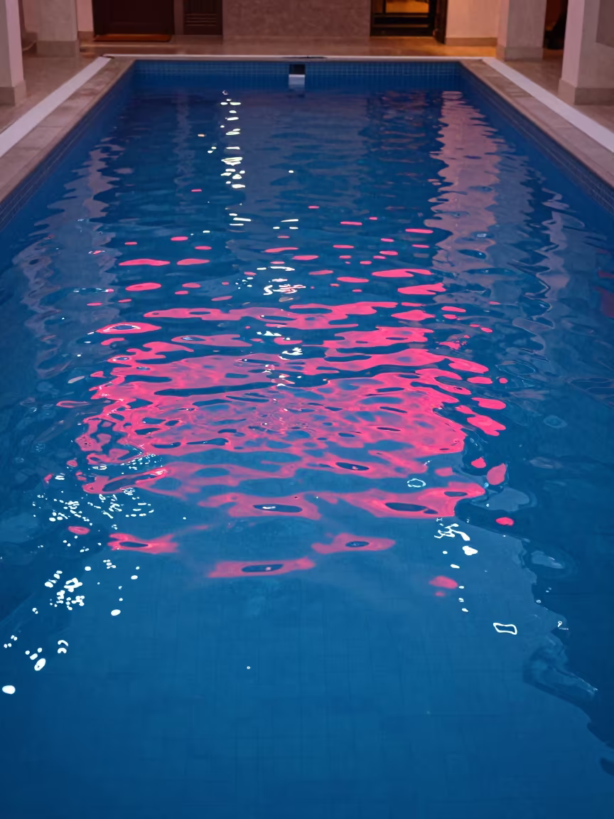 Neon Reflections on Pool Surface at Dusk in inside a skylit passageway in Dire Dawa