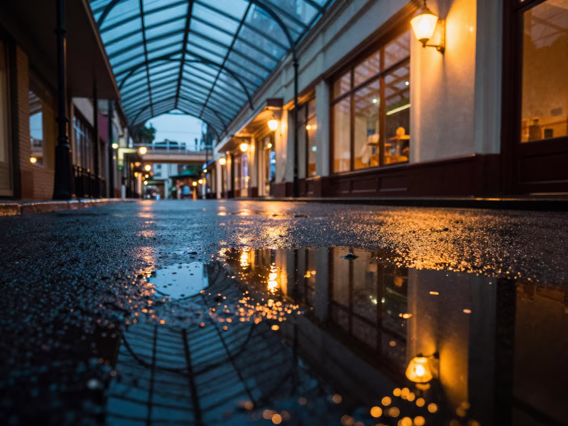 Neon Reflections in Rainy Season Puddle in inside a glass-roofed arcade near Chililabombwe