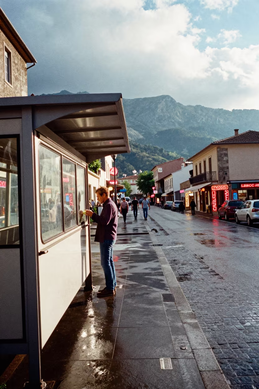 Neon Reflections on Wet Pula Pavement in beside a steamed-up bus shelter in Pula