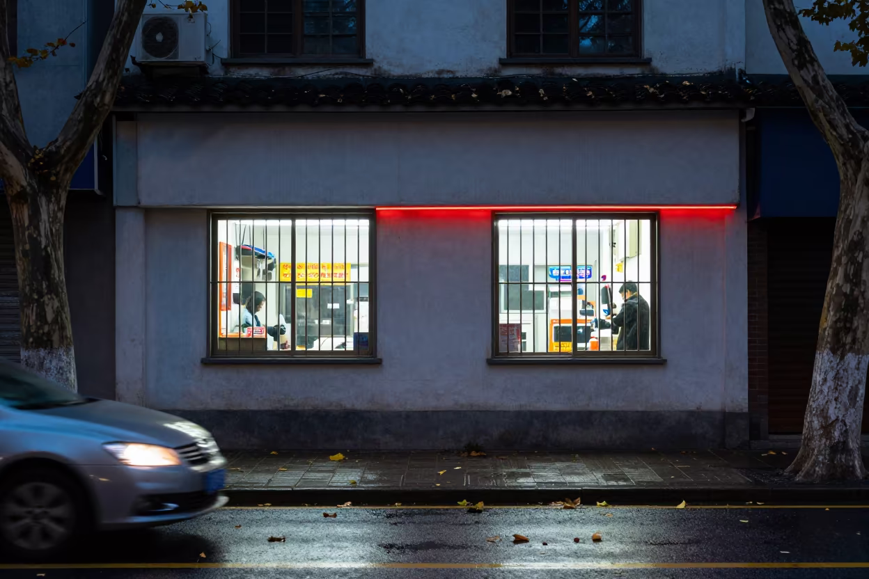 Neon storefront on wet Suzhou street at blue hour in outside a corner cafe in Suzhou