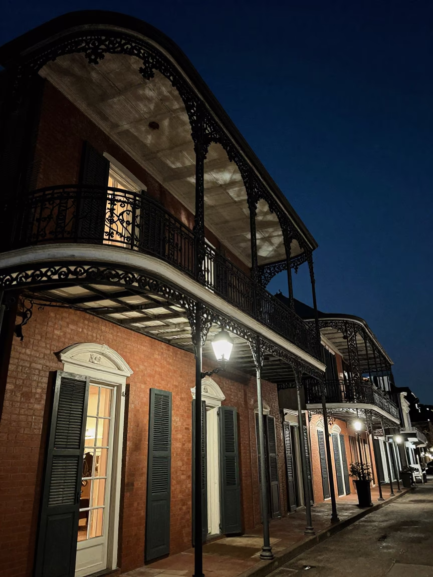 New Orleans French Quarter Balcony Night Scene with Wrought Iron and Streetlights in in New Orleans, Louisiana, United States