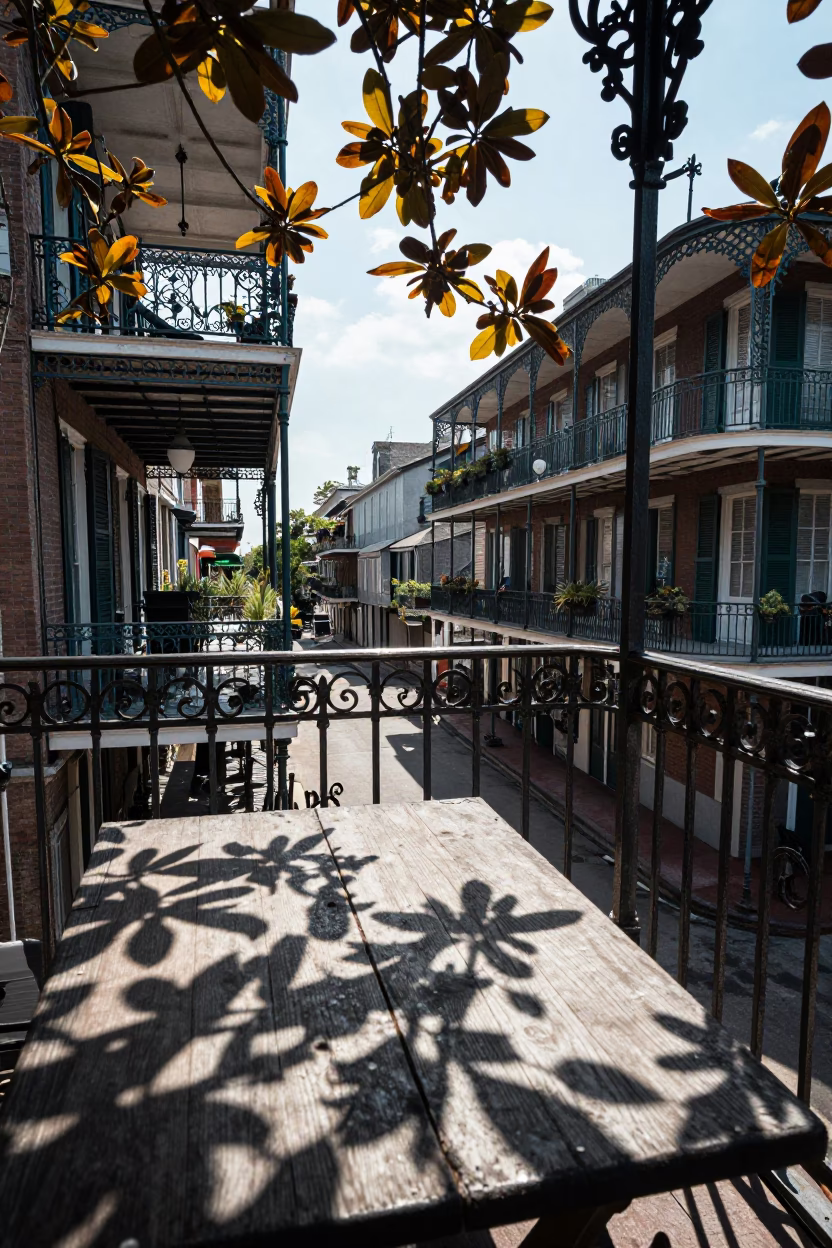 New Orleans French Quarter balcony with ironwork and leaf shadows in bright midmorning light in in New Orleans, Louisiana, United States