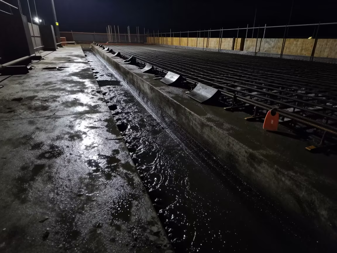 Night Concrete Pour Lane Moonlit Rain Slurry in on an active construction deck in Mauritius