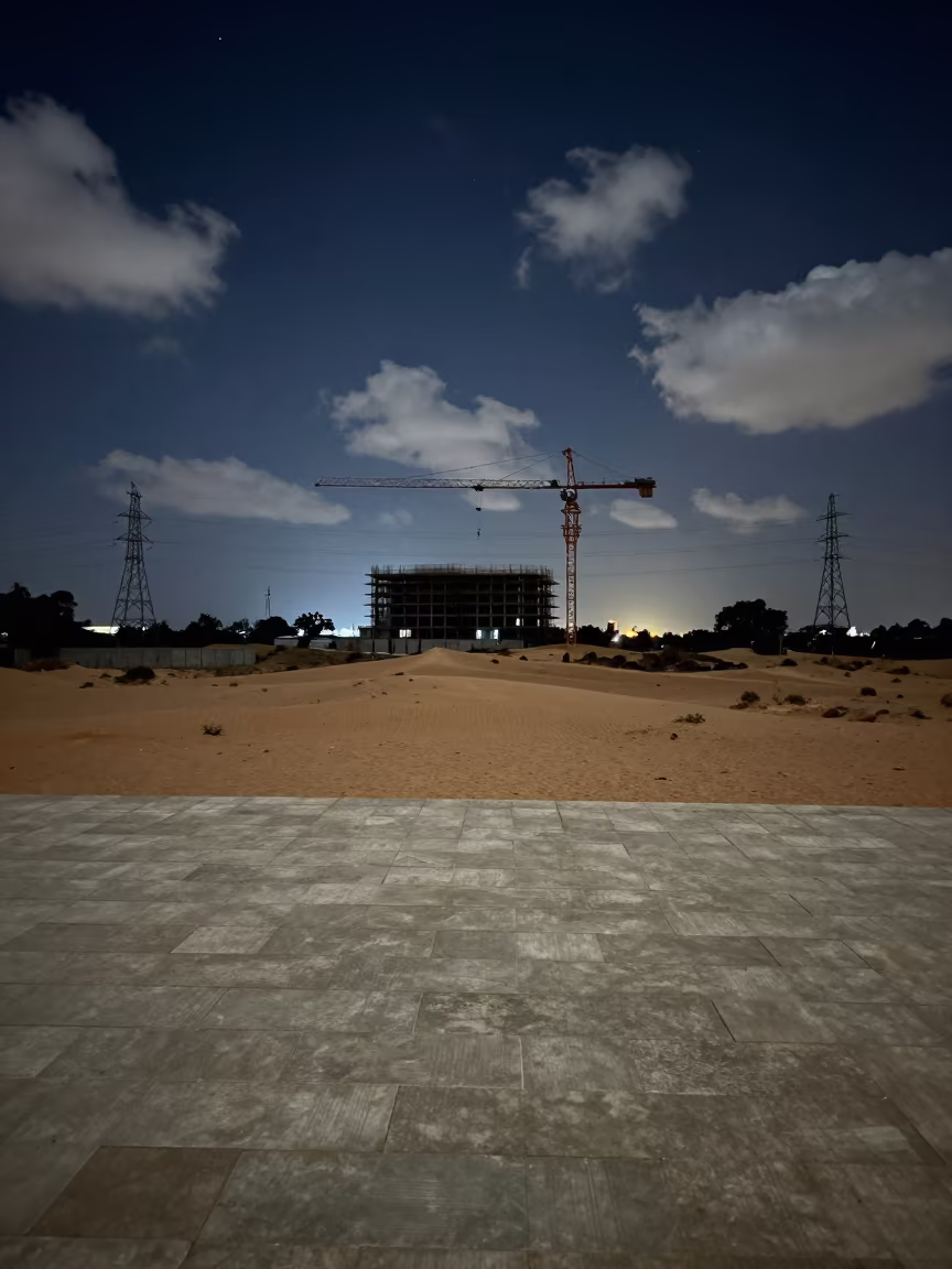 Night Crane Over Malawi Sand Dunes in under gantries and utility towers in Malawi