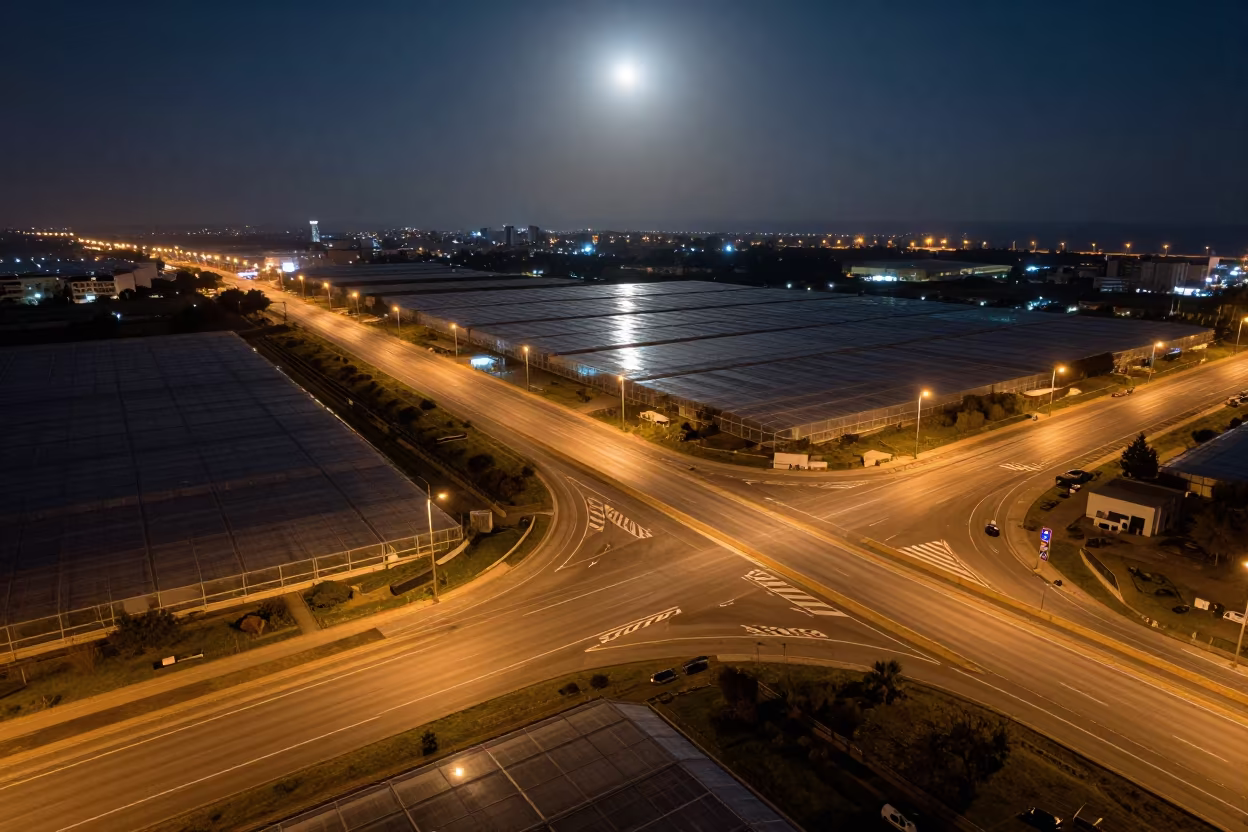 Night highway interchange aerial view over Netanya in high over greenhouse grids near Netanya