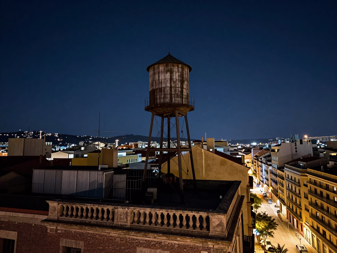 Night Sky Barcelona Rooftop Water Tower and Urban Street Life in in Barcelona, Spain